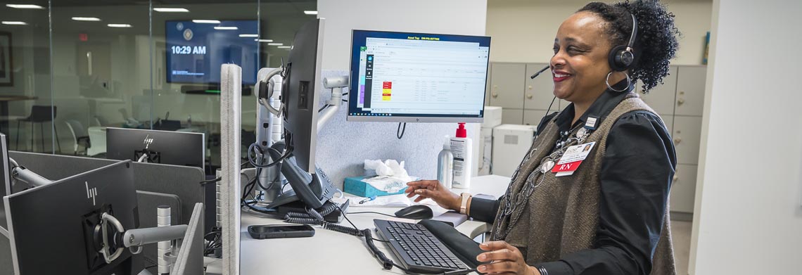 OSF OnCall nurse performing patient-driven triage from a digital health communications center.